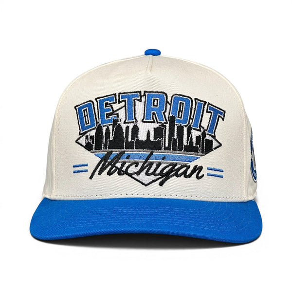 Detroit Snapback - The Sanders (Cream/Electric Blue) features a vintage-style design with DETROIT and skyline embroidery, reminiscent of retro Detroit Lions gear.