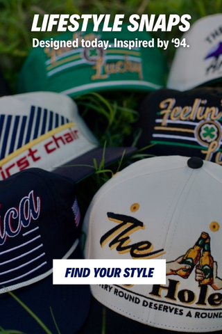 Lifestyle snapback hats in a bed of grass promoting the "Lifestyle Snaps" collection.