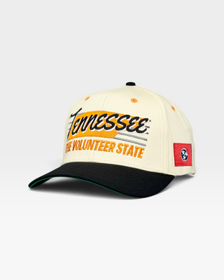 Tennessee Snapback - The Neyland (Cream/Black): Vintage-style cap with Tennessee embroidery, nodding to Neyland Stadium's vibrant history. Features a Tennessee state flag patch.