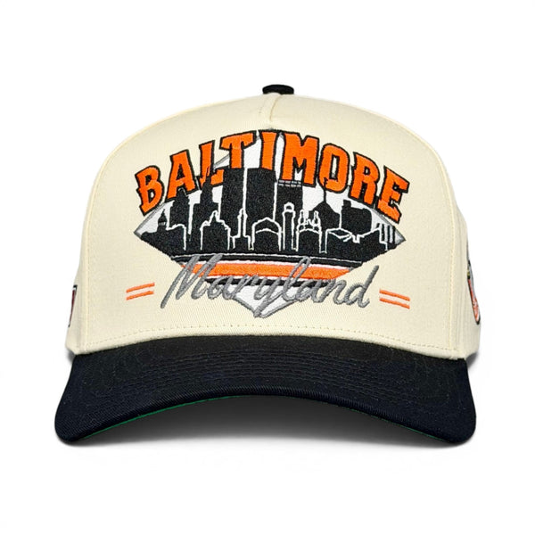 Retro Baltimore Snapback - The Ripken baseball cap with embroidered football-shaped skyline, large BALTIMORE text, ideal for Camden Yards days.