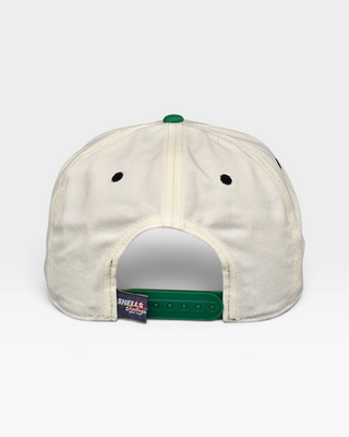 Retro-styled Boston Snapback - The Bird with green snap closure, ventilation holes, and Shells Vintage Hat Co. label, celebrating vintage Celtics spirit.