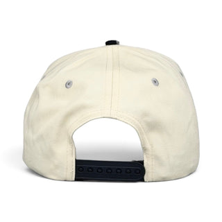Chicago Snapback - The Comiskey, showcasing a vintage-style beige baseball cap with black snap-back, honoring the White Sox with retro South Side simplicity.