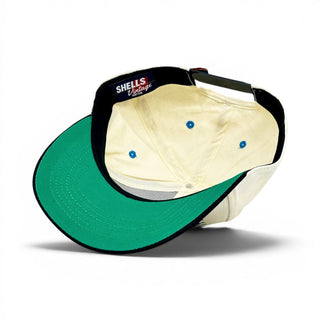 Kentucky Snapback - The Rupp, featuring a green bill underside, cream inner panels, blue eyelets, black sweatband, and SHELLS Vintage Hat Co. woven label.
