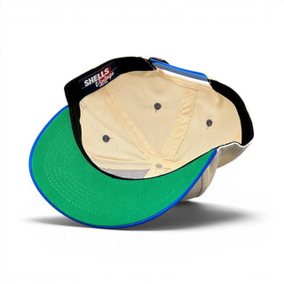 Interior view of Kentucky Snapback - The Rupp (Cream/Blue), showcasing tan liner, green brim underside, blue edge binding, and “Shells Vintage Hat Co.” label.