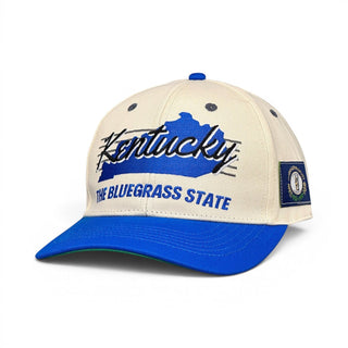 Kentucky Snapback - The Rupp features a tan crown, blue bill, and blue embroidered Kentucky outline with Kentucky script, plus state seal patch.