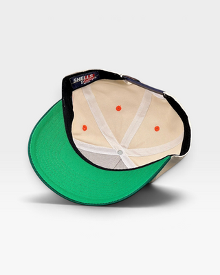 Inside view of the Miami Snapback - The U, featuring retro green brim, beige paneling, orange stitching, and Shells Vintage Hat Co. label, evoking Miami Hurricanes nostalgia.