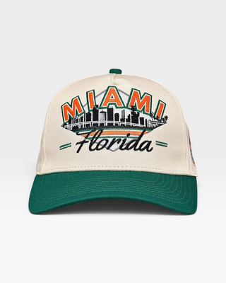 Retro Miami Snapback - The U featuring a beige crown, green brim, and Miami skyline embroidery. A throwback to the iconic 2001 Hurricanes football era.