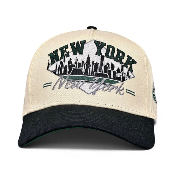 Retro New York Snapback - The Revis, featuring a stylized Manhattan skyline and cursive script, celebrating the Mets and Jets with vintage flair.