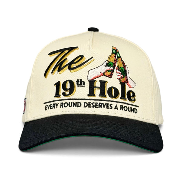 Retro The 19th Hole snapback with a golf-bar theme, featuring embroidered beer bottles and slogan Every round deserves a round. Perfect for casual, fun-loving golfers.